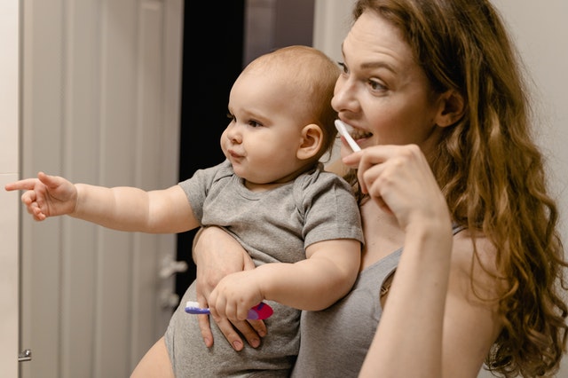 Сhild and mother brushing teeth